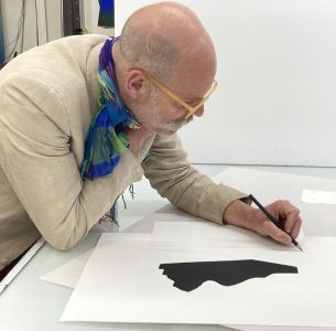 Artist Gavin Turk signing his limited edition print